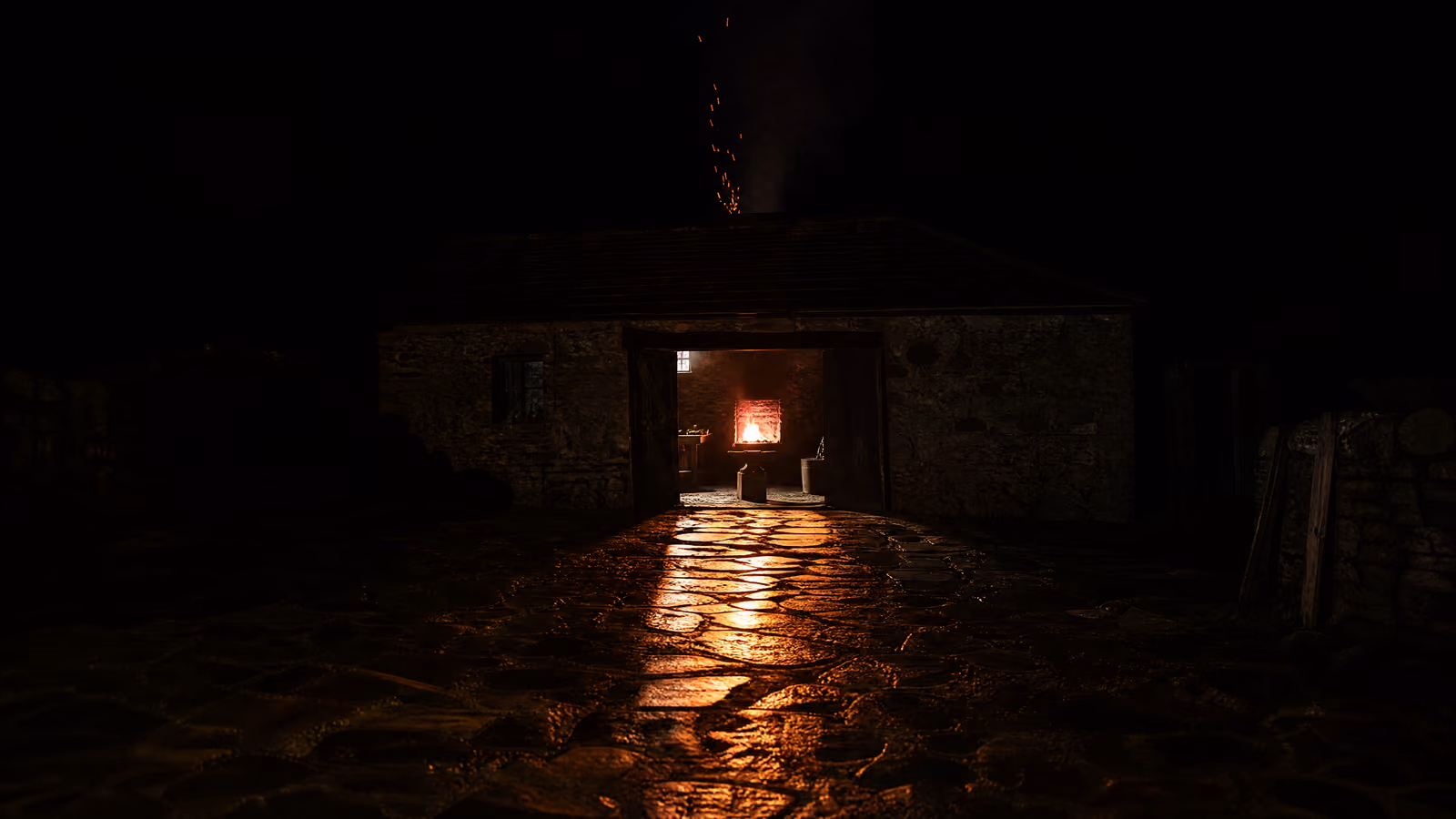 A forge at night seen from across a dark yard, its open doorway throwing warm light over wet flagstones towards the viewer.