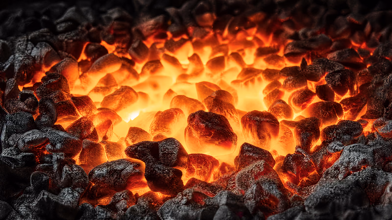 A bed of coals at working heat, white at the centre.